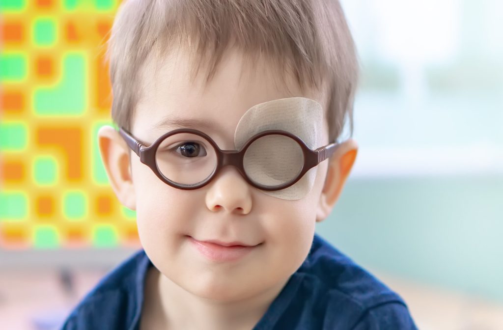 A young boy wears an occlusion patch